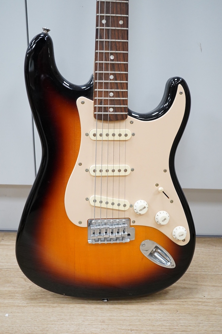 A Fender Squire electric guitar, with a Kinsman soft case, together with a Peavey VYPYR 15W modelling amplifier
